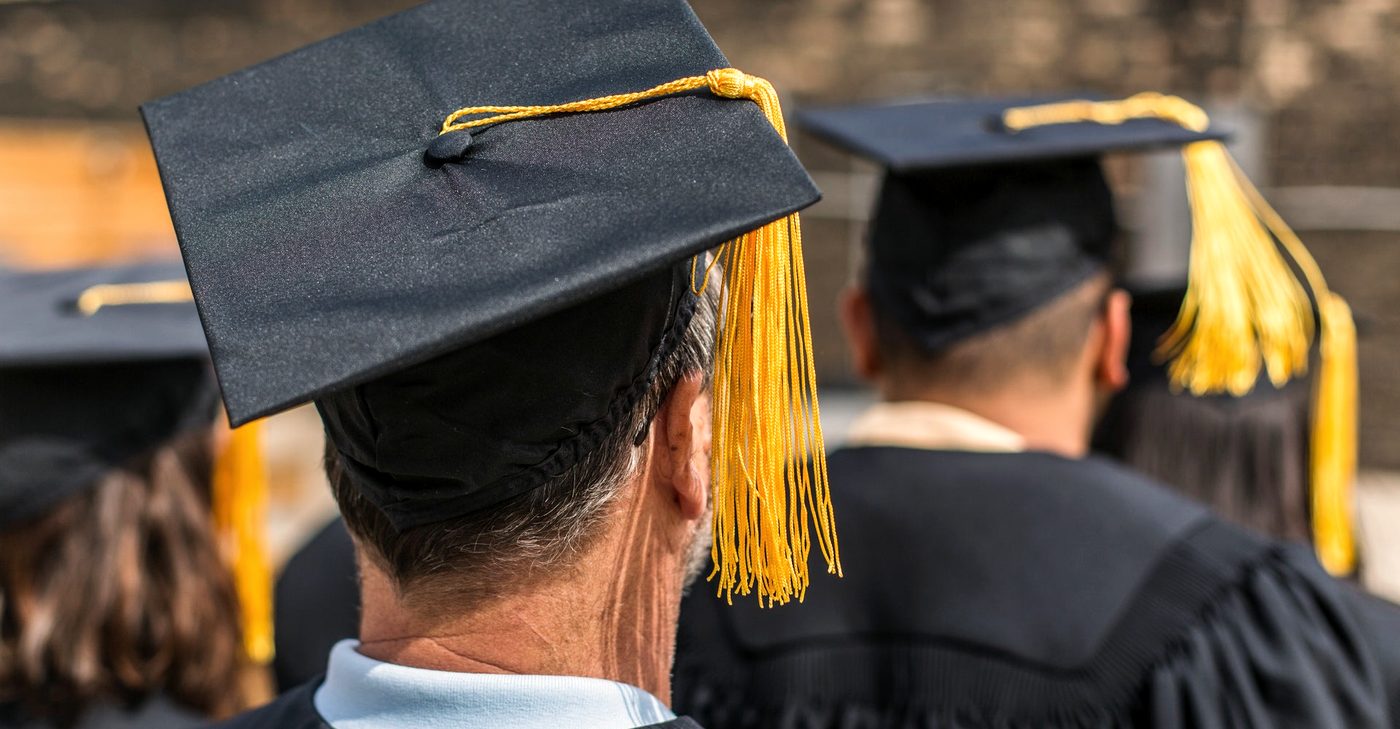 Graduates in caps and gowns at a commencement ceremony